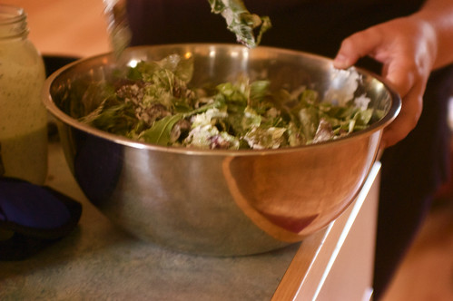 tossing the salad with ranch dressing