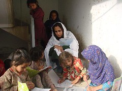 Fauzia Minallah helping children with colouring