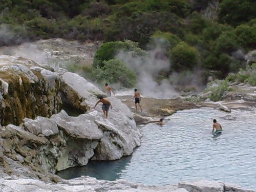 Kids swimming below the erupting guyser