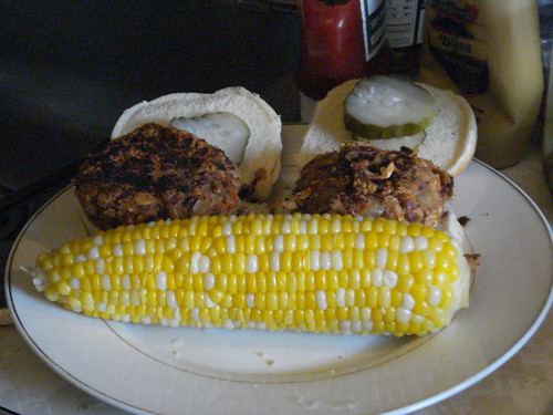 Burgers and corn plated and ready to eat