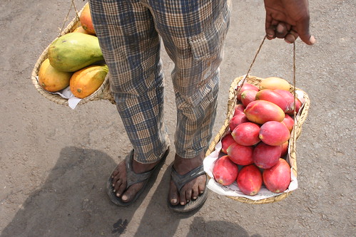 vendor selling papayas and mangoes