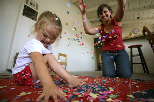 mom and child playing with confetti 