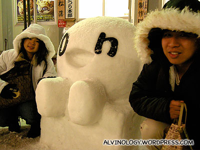 Meiyen and Mark, posing with a cute looking tiny snow sculpture