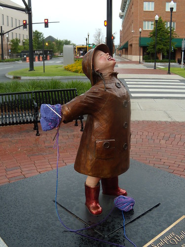 Girl in the rain statue with yarn