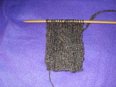 spun sheep wool being knit into scarf