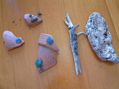 Broken pottery, stick and piece of bark