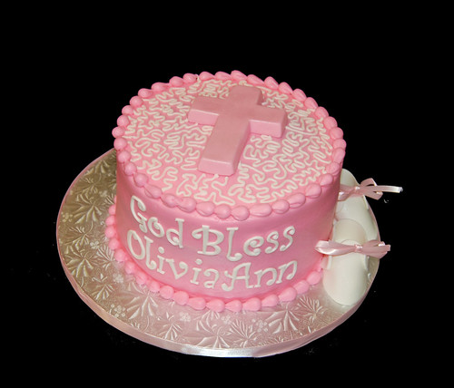 pink baptism cake with cross and baby shoes
