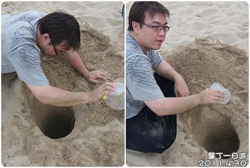 110430-在沙攤上挖洞的男人