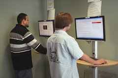 Students at general-use computers in hallway by Ohlone College