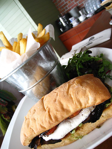 Sandwich of Grilled Brie Cheese, Avocado & Portobello Mushroom served with Chips