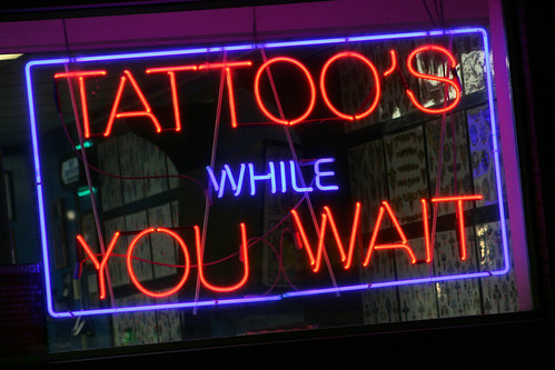 I think Charlie got tired of people leaving their body parts to get tattoos and not coming back to get them, so he had to advertise "Tattoos while you wait" 