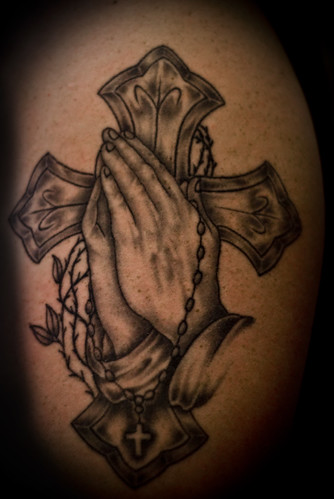 My brother Mike's tattoo of a cross with praying hands, and a rosary draped 