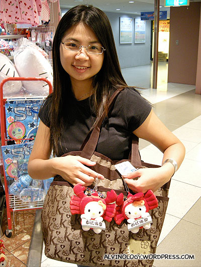 Meiyen trying to steal some Hello Kitty toys