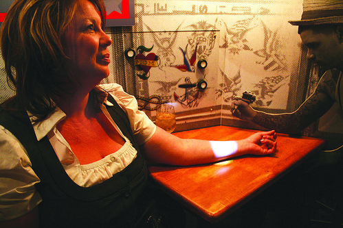 Debbie Eastwood tries out the “Original Uncle Sam Tattoo-A-Tron” (Sabrina 