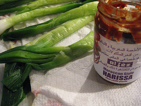 Griddled spring onions with harissa