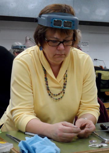 Karen Jankowski works on a piece of jewelry in class.