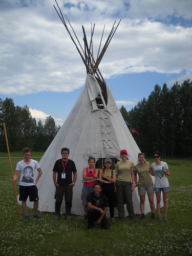 group shot of volunteers and tipi at rocky mountain house