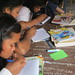 Schoolgirls taking notes during a lesson at UWS Rock School, Cambodia