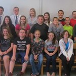 Students and professors pose with middle school students