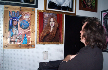 Bill Foss with a few of his paintings on copper.