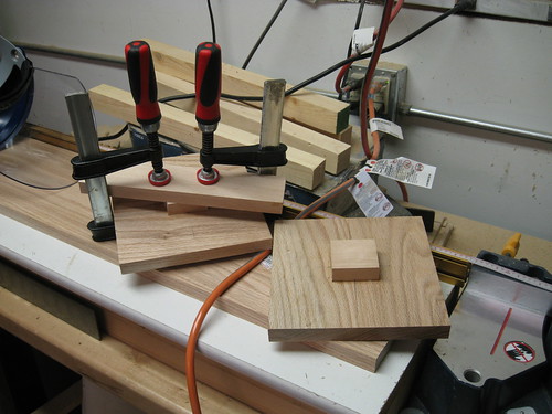 birch squares being glued to red oak panels for chucking in lathe and turning into flat dishes