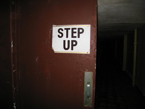 Step up sign on door to tunnel