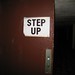 Step up sign on door to tunnel