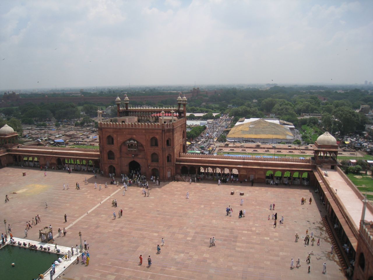 A view toward the main gate of Jama Masjid from atop a minaret, with Delhi's Red Fort in the distance.