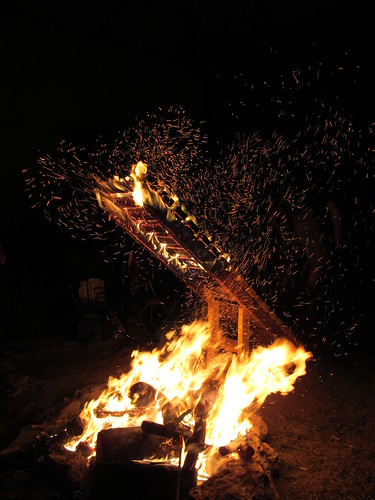 A large, burning campfire at night