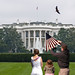 A father prepares to fly a kite on the front lawn of the White House