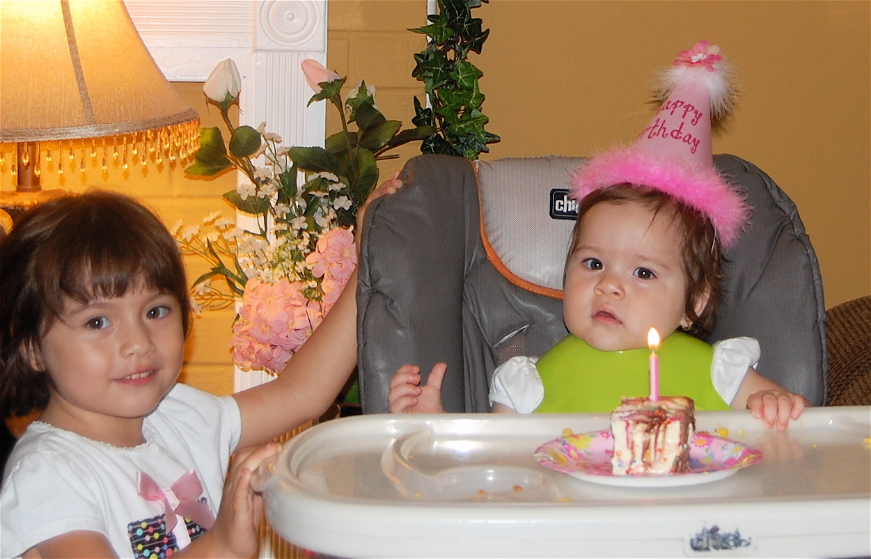 big sis helped her blow out the candle