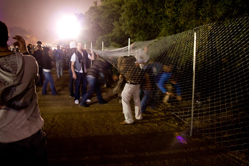 Crowd breaking through fence