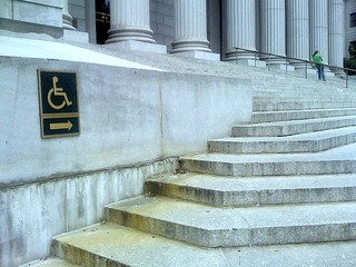 wheelchair sign pointing at steps