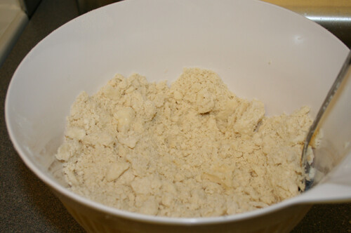Mix together flour, shortening, sugar, and salt with a fork until crumbly.