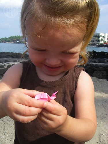 her pink origami frog is saying cheese for the photo