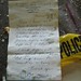 Discarded note amidst police debris