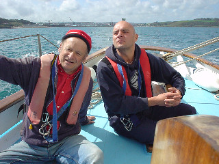 Adam points out the destination to Petr on the helm of Eve of St Mawes