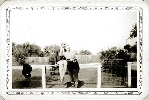 Our Laura in jodhpurs with friend on fence