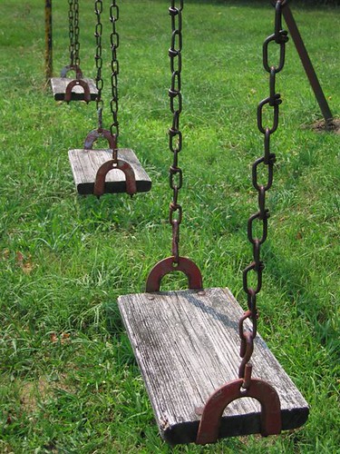 Rusty metal and wood swingset