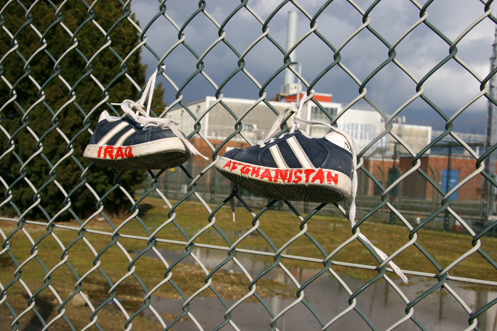 Childrens Shoes on the fence