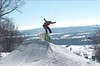 A snowboarder boardslides a jib in the terrain park at Devils Head Resort, Wisconsin