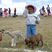 Little girl at Huanuco Pampa competitions with lamb and puppy