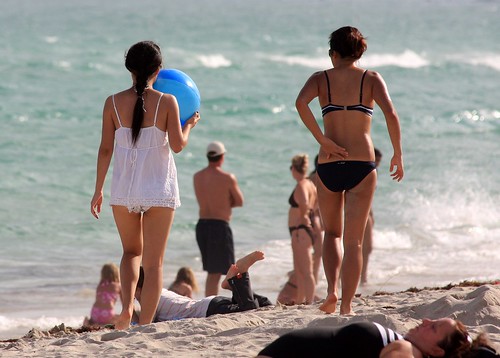 Girl on bikini and girl on baby doll walking by South Beach Miami