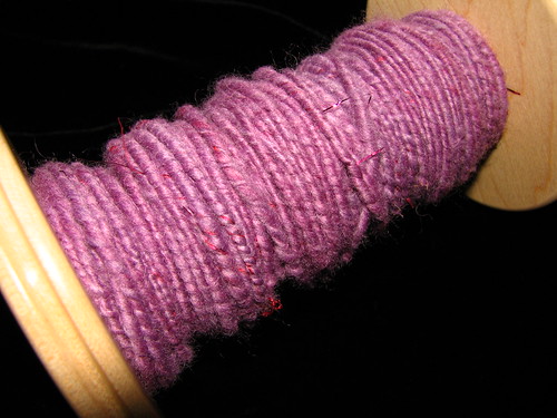On the bobbin....purple roving with pink lurex bits.