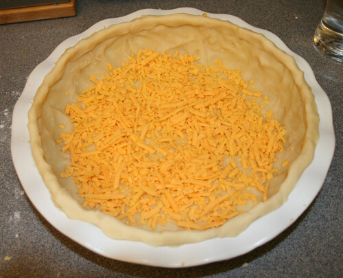 Spread half the cheese onto the crust.