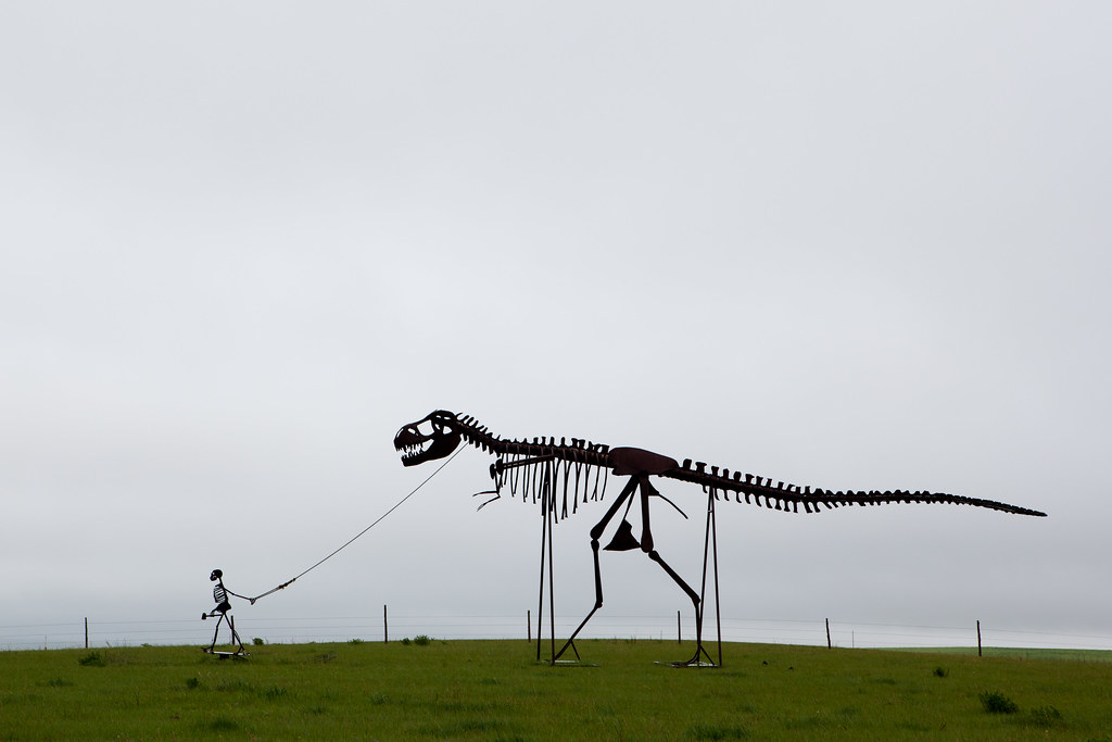 Skeleton walking a dinosaur....