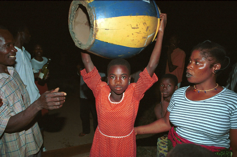 Togo West Africa Ethnic Cultural Dancing and Drumming African Village close to Palimé formerly known as Kpalimé a city in Plateaux Region Togo near the Ghanaian border 24 April 1999 003 Local Girl with Drum<br/>© <a href="https://flickr.com/people/41087279@N00" target="_blank" rel="nofollow">41087279@N00</a> (<a href="https://flickr.com/photo.gne?id=3237033829" target="_blank" rel="nofollow">Flickr</a>)