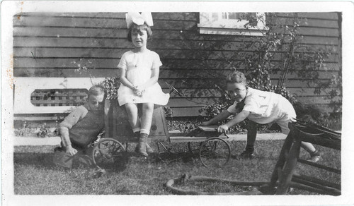 Two boys, a girl and a car.