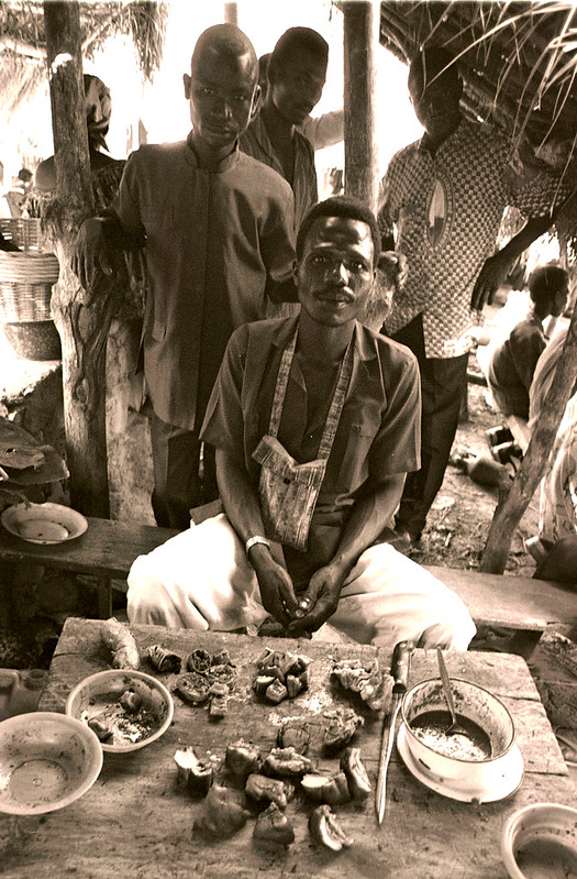 Togo West Africa Village Market Togolese Ladies close to Palimé formerly known as Kpalimé a city in Plateaux Region Togo near the Ghanaian border B&W Sepia 24 April 1999 Roast Pork  006 Market Roast Pork<br/>© <a href="https://flickr.com/people/41087279@N00" target="_blank" rel="nofollow">41087279@N00</a> (<a href="https://flickr.com/photo.gne?id=3237876394" target="_blank" rel="nofollow">Flickr</a>)