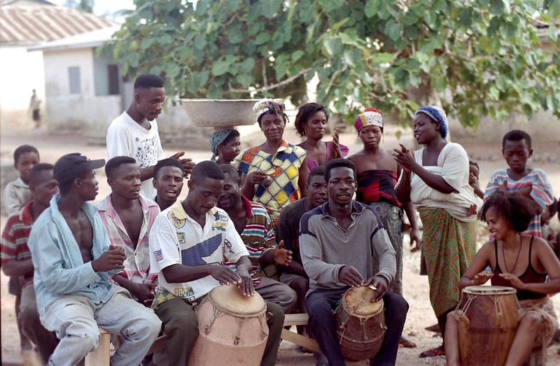 Togo West Africa Ethnic Cultural Dancing and Drumming African Village close to Palimé formerly known as Kpalimé a city in Plateaux Region Togo near the Ghanaian border 24 April 1999 022 African Village Drummers with Fouzia<br/>© <a href="https://flickr.com/people/41087279@N00" target="_blank" rel="nofollow">41087279@N00</a> (<a href="https://flickr.com/photo.gne?id=3278236362" target="_blank" rel="nofollow">Flickr</a>)